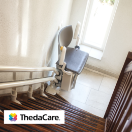 Stair lift on the bottom of the stairs in a home