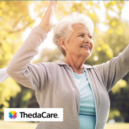 Elderly women outside exercising with their hands up in the air