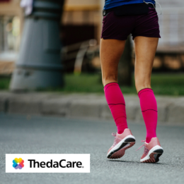 Woman running outside with compression socks on