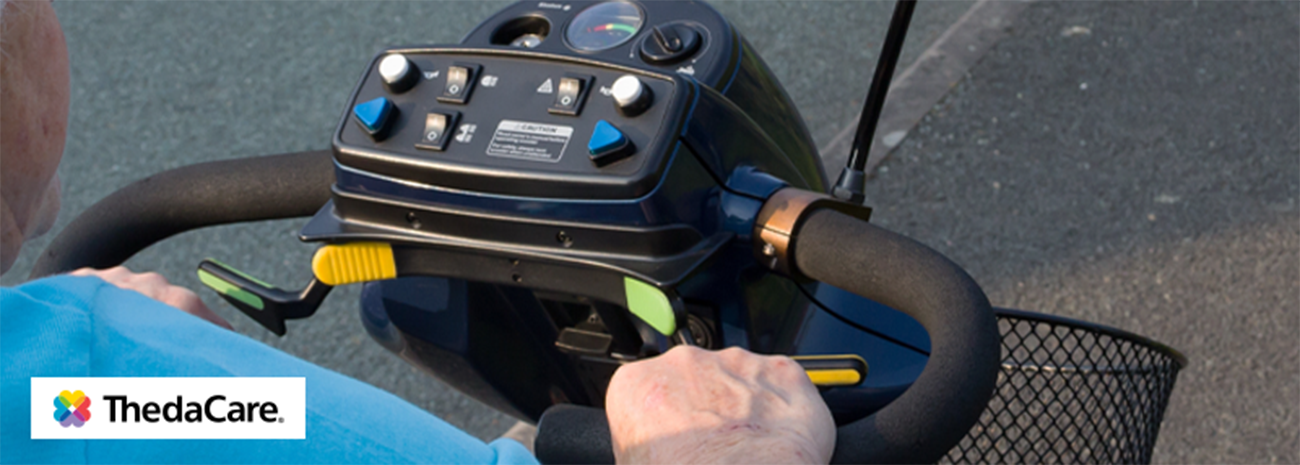 Image shows older individual steering mobility scooter on pavement