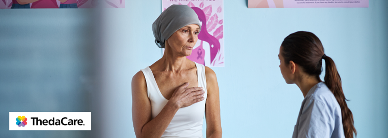Woman with head wrap at a mastectomy bra fitting with fitter