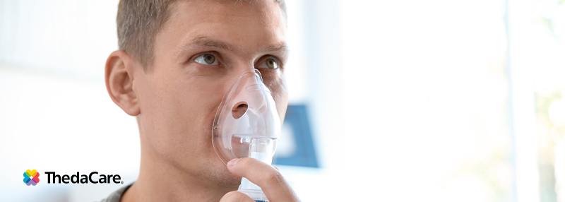 Young man using a nebulizer