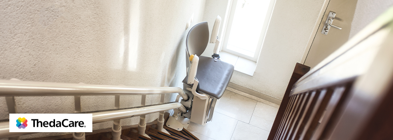 Stair lift on the bottom of the stairs in a home