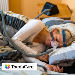 Woman sleeping on her side with a CPAP mask on