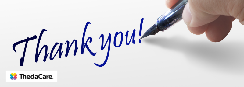 Thank you being written on white background with fountain pen and hand in blue ink