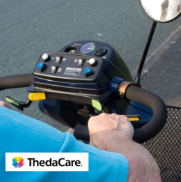 Image shows older individual steering mobility scooter on pavement