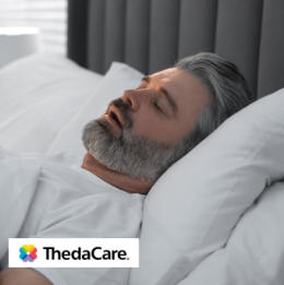 Man lying in bed sleeping with his mouth open