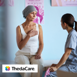 Woman with head wrap at a mastectomy bra fitting with fitter