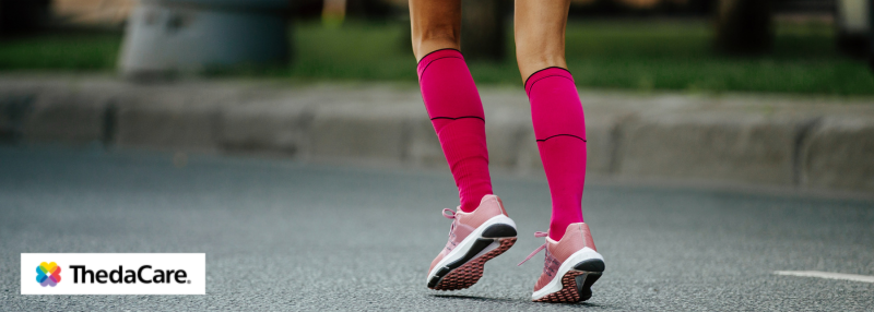 Woman running outside with compression socks on